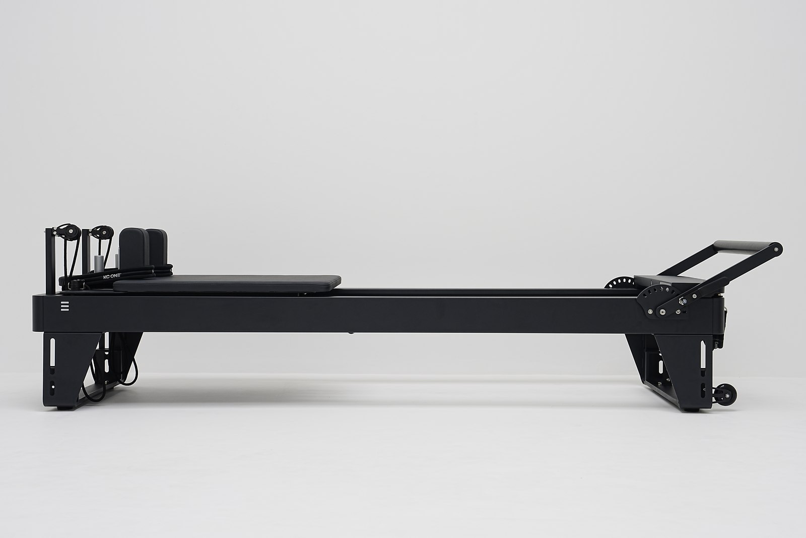 Temnox Reformer TSH — professional Pilates reformer, black, studio side view